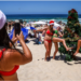 Tourists pose for a photo at Sydney's Bondi Beach on December 25, 2024. David Gray/AFP/Getty Images